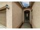 Inviting front entrance featuring textured walls, arched doorway and a dark, elegant front door at 4459 Lavender, Pahrump, NV 89061