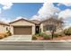 Charming single-story home featuring a tile roof, attached garage, and lovely desert landscaping at 4459 Lavender, Pahrump, NV 89061