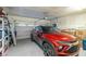 Two car garage with a red SUV parked in the driveway at 4459 Lavender, Pahrump, NV 89061