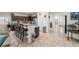 A spacious kitchen featuring dark wood cabinetry, granite countertops, and a large breakfast bar with seating at 4459 Lavender, Pahrump, NV 89061