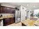 A bright kitchen featuring dark wood cabinets, granite countertops, and stainless steel appliances at 4459 Lavender, Pahrump, NV 89061