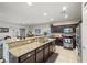 This kitchen offers dark wood cabinets, granite countertops, stainless appliances, and tile flooring at 4459 Lavender, Pahrump, NV 89061
