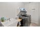 Well-equipped laundry room with modern washer, dryer, utility sink, and shelving at 4459 Lavender, Pahrump, NV 89061