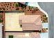 An aerial shot showcasing the roof and backyard of a home with red rock landscaping at 4571 S Via Roma Dr, Pahrump, NV 89061
