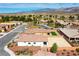Expansive aerial view shows a neighborhood with desert landscaping, featuring the green turf and mountains in distance at 4571 S Via Roma Dr, Pahrump, NV 89061