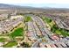 An aerial view shows a residential community with a golf course and surrounding mountains at 4571 S Via Roma Dr, Pahrump, NV 89061
