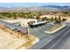 Aerial view of a community retail space featuring gas station, bus, auto services, and views of desert mountains at 4571 S Via Roma Dr, Pahrump, NV 89061