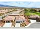 Panoramic aerial shot featuring a residential area near a golf course, with mountain views in the distance at 4571 S Via Roma Dr, Pahrump, NV 89061