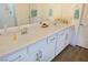 Bathroom with double sinks, vanity with drawers, and wood-look floors at 4571 S Via Roma Dr, Pahrump, NV 89061