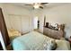Comfortable bedroom with large closet, ceiling fan, and ample natural light from window at 4571 S Via Roma Dr, Pahrump, NV 89061