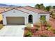 Charming single-story home with low-maintenance landscaping, a two-car garage, and a welcoming entryway at 4571 S Via Roma Dr, Pahrump, NV 89061