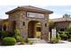 The stone archway welcomes residents and guests into the Restaurant and Residents Facility, surrounded by manicured landscaping at 4571 S Via Roma Dr, Pahrump, NV 89061