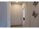 Clean hallway with neutral walls, wood-look flooring, and decorative butterfly accents at 4571 S Via Roma Dr, Pahrump, NV 89061
