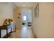 Bright hallway with wood-look tile flooring leading to a spacious living area with modern décor at 4571 S Via Roma Dr, Pahrump, NV 89061