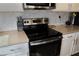 Modern kitchen features stainless steel oven, white cabinets, and stone tile backsplash at 4571 S Via Roma Dr, Pahrump, NV 89061