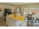 Bright, open-concept living space with island kitchen, dining area and sliding glass doors to backyard at 4571 S Via Roma Dr, Pahrump, NV 89061