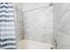 This bathroom includes neutral toned tiling and a clean shower curtain for privacy at 466 Las Casitas Way, Las Vegas, NV 89121