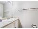 This half bath is complete with a large mirror and a charming granite countertop at 466 Las Casitas Way, Las Vegas, NV 89121