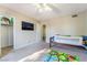 This bedroom features a ceiling fan, a sizable entertainment center, and a large window at 466 Las Casitas Way, Las Vegas, NV 89121