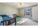 This bedroom features a ceiling fan, and includes a large window for natural light at 466 Las Casitas Way, Las Vegas, NV 89121