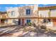 View of townhome featuring a stucco exterior with a well maintained yard at 466 Las Casitas Way, Las Vegas, NV 89121