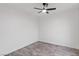 Minimalist bedroom with wood-look flooring, a ceiling fan, and bright white walls at 4905 Madre Maria Ct, North Las Vegas, NV 89031