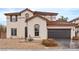 Charming two-story stucco home featuring a tile roof, two car garage, and desert landscaping at 4905 Madre Maria Ct, North Las Vegas, NV 89031