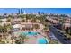 Aerial view of a community featuring lush landscaping, a pool, and views of the downtown skyline at 5422 River Glen Dr # 373, Las Vegas, NV 89103