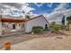 A covered patio area and desert landscaping is shown in the backyard of this home at 630 Otono Dr, Boulder City, NV 89005