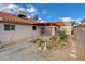 View of the backyard showing a covered patio, mature landscaping and surrounding block wall at 630 Otono Dr, Boulder City, NV 89005