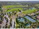 Beautiful aerial view of a community featuring a golf course, tennis courts and lush landscaping at 71 Fountainhead Cir, Henderson, NV 89052