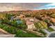 Beautiful aerial view of a landscaped home with mountain views and a neutral colored exterior at 71 Fountainhead Cir, Henderson, NV 89052
