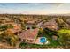 A beautiful home featuring a lush green lawn, a pool, and landscaping at 71 Fountainhead Cir, Henderson, NV 89052