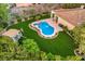 Aerial view of a home with a perfectly maintained yard, pool, and play area at 71 Fountainhead Cir, Henderson, NV 89052