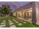 Spacious backyard featuring a patio, green lawn with stepping stones, and mature landscaping at 71 Fountainhead Cir, Henderson, NV 89052