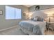 Light and airy bedroom featuring a comfortable bed with blue and white bedding and soft, neutral decor at 71 Fountainhead Cir, Henderson, NV 89052