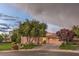 Attractive single-story home with manicured landscaping, mature trees, and a two-car garage at 71 Fountainhead Cir, Henderson, NV 89052