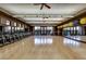 Spacious fitness center with rows of exercise bikes, hardwood floors, large mirrors, and floor to ceiling windows at 71 Fountainhead Cir, Henderson, NV 89052