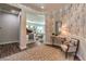 Elegant foyer with neutral decor, patterned wallpaper, a curved archway, and hardwood floors at 71 Fountainhead Cir, Henderson, NV 89052