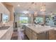 Open kitchen with large island, stainless appliances, and view of the backyard and living area at 71 Fountainhead Cir, Henderson, NV 89052