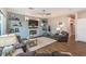 Cozy living room with a fireplace, TV, shiplap accent wall and wood-look floors at 71 Fountainhead Cir, Henderson, NV 89052