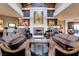 Elegant lobby area with comfortable seating, a stone fireplace, decorative art, and stylish interior design elements at 71 Fountainhead Cir, Henderson, NV 89052