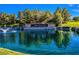 Picturesque view of a pond with a water fountain, surrounded by lush greenery and a stone sign for Anthem Country Club at 71 Fountainhead Cir, Henderson, NV 89052