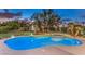 Beautiful backyard pool and spa area with a playhouse and lush landscaping at 71 Fountainhead Cir, Henderson, NV 89052