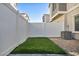 Low-maintenance backyard with artificial turf and rock landscaping, enclosed by a white fence at 7348 N Decatur Blvd # 5, Las Vegas, NV 89131