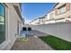 Enclosed backyard featuring a gravel ground covering, artificial turf, and a white fence at 7348 N Decatur Blvd # 5, Las Vegas, NV 89131