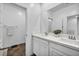 Bright bathroom featuring double sinks, a large mirror and a dark brown tile floor at 7348 N Decatur Blvd # 5, Las Vegas, NV 89131