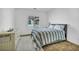 A cozy bedroom featuring a plush rug, a comfortable queen bed, and natural light from the window at 7348 N Decatur Blvd # 5, Las Vegas, NV 89131