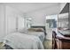 Bedroom with a large bed, a dresser with TV and two bright windows at 7348 N Decatur Blvd # 5, Las Vegas, NV 89131