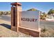 Roxbury community entrance sign features stone accents and professional landscaping to enhance the neighborhood's appeal at 7348 N Decatur Blvd # 5, Las Vegas, NV 89131